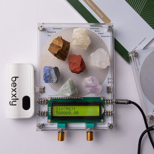 A Bexxly Harmonia Sequence Pro crystal resonance analyzer kit shown on a white background, featuring a clear square circuit board with various colored crystals, a green LCD screen, a white Bexxly device, and its green and white manual.